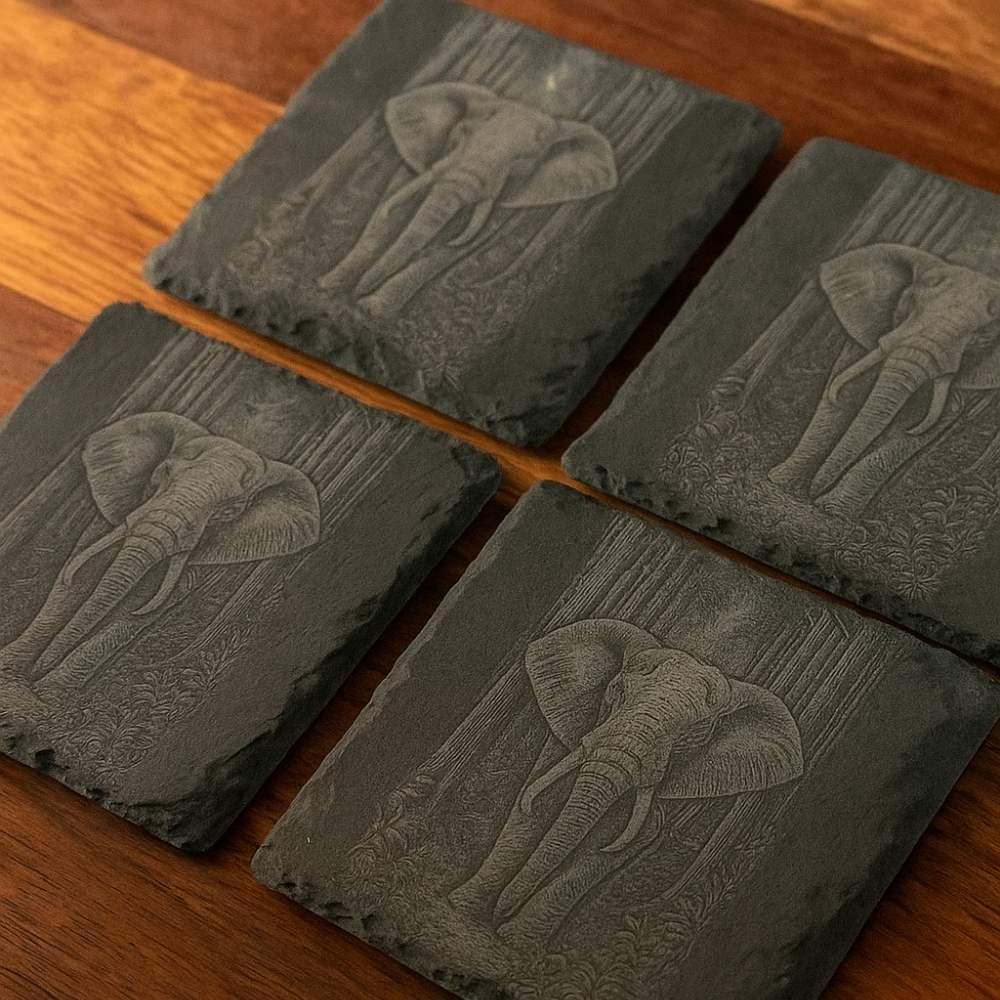 Natural slate drinks coaster featuring detailed elephant engraving