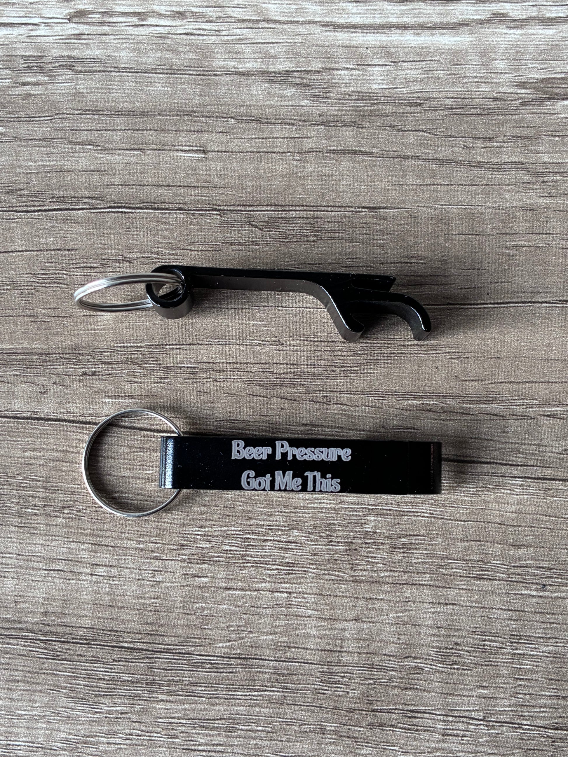 Bottle opener and keychain with text on a wooden surface
