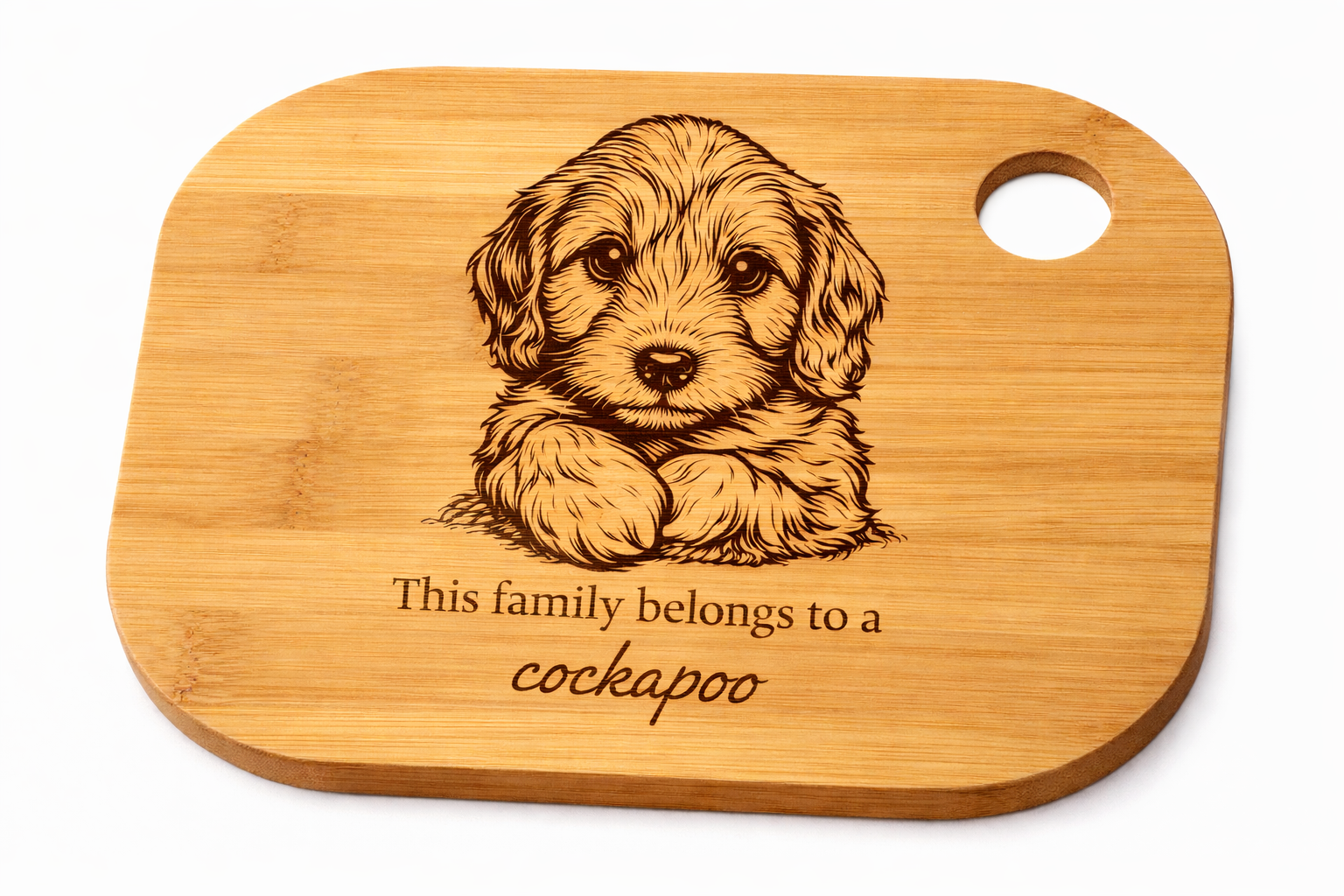 Wooden cutting board with a engraved cockapoo puppy illustration and text on a white background