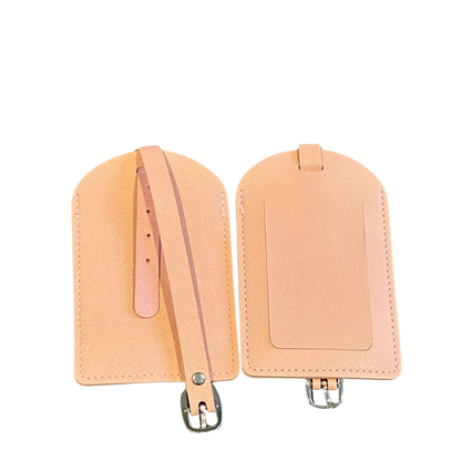 Two pink-colored luggage tags with straps on a white background