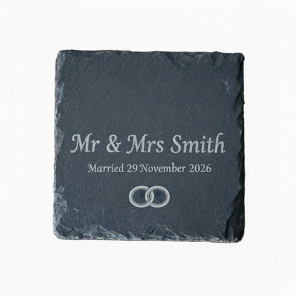 Personalized slate coaster with engraved text 'Mr & Mrs Smith Married 29 November 2026' on a white background