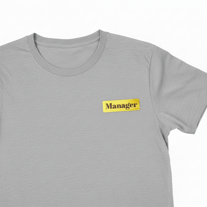 Gold Coasted Name Badge Engraved with Manager Pinned to T-shirt