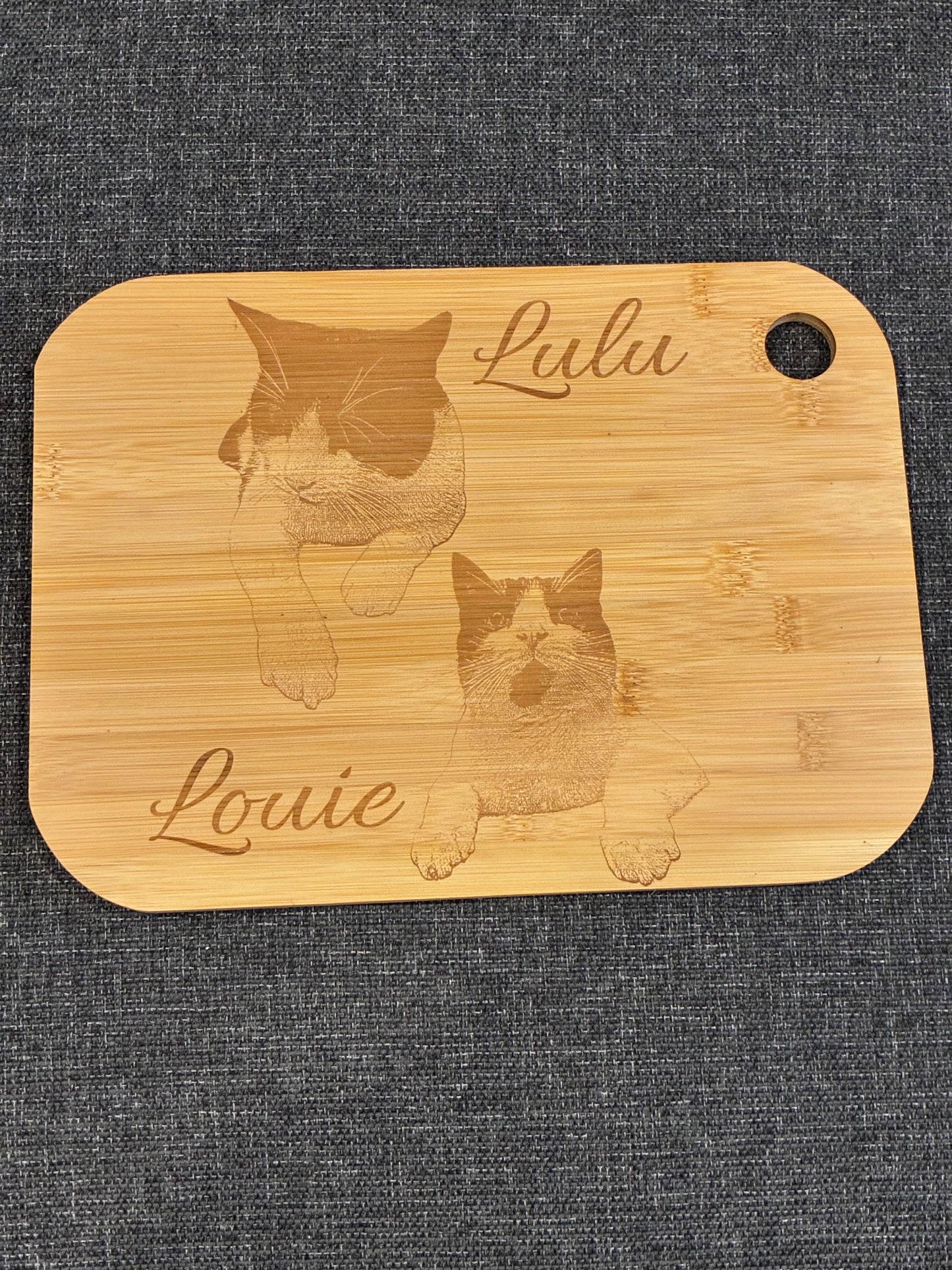 Personalised engraved board showing an illustrated pair of cats with decorative names