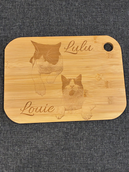 Personalised engraved board showing an illustrated pair of cats with decorative names