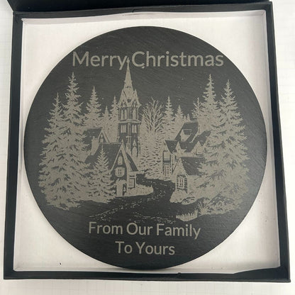 Round slate serving board engraved with Christmas village design and festive message