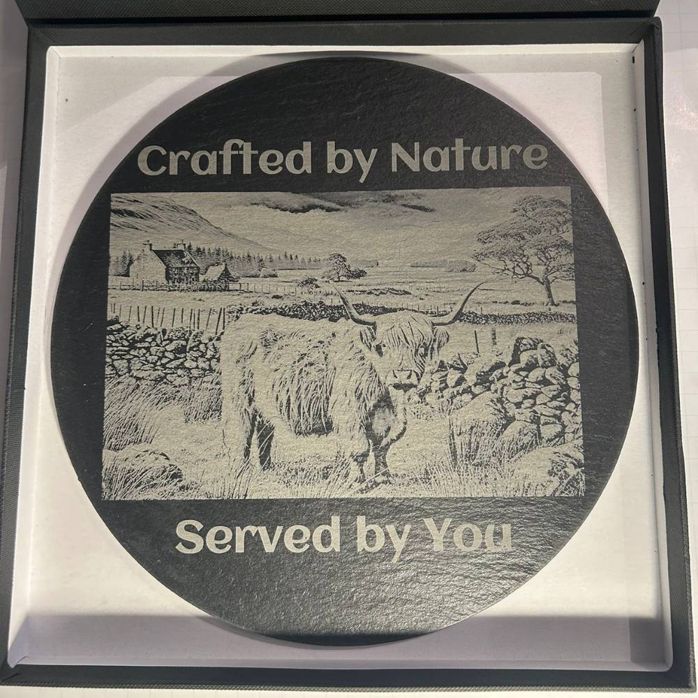 Round slate serving board engraved with “Crafted by Nature, Served by You” design
