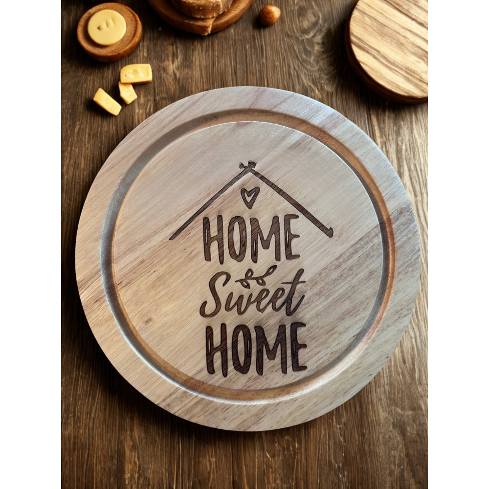 Wooden cheeseboard with 'Home Sweet Home' engraving on a wooden surface.| UK