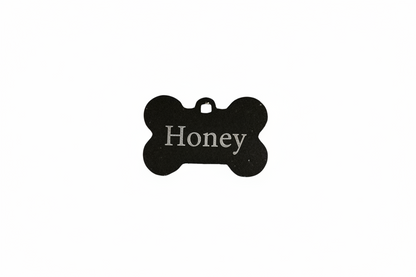 Black bone-shaped tag on a white background with name Honey engraved