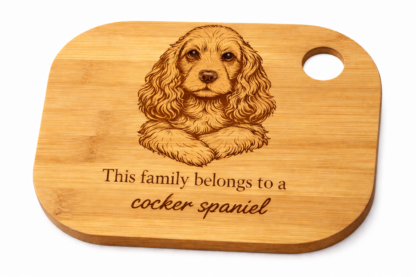 Wooden cutting board with a engraved cocker spaniel and text on a white background