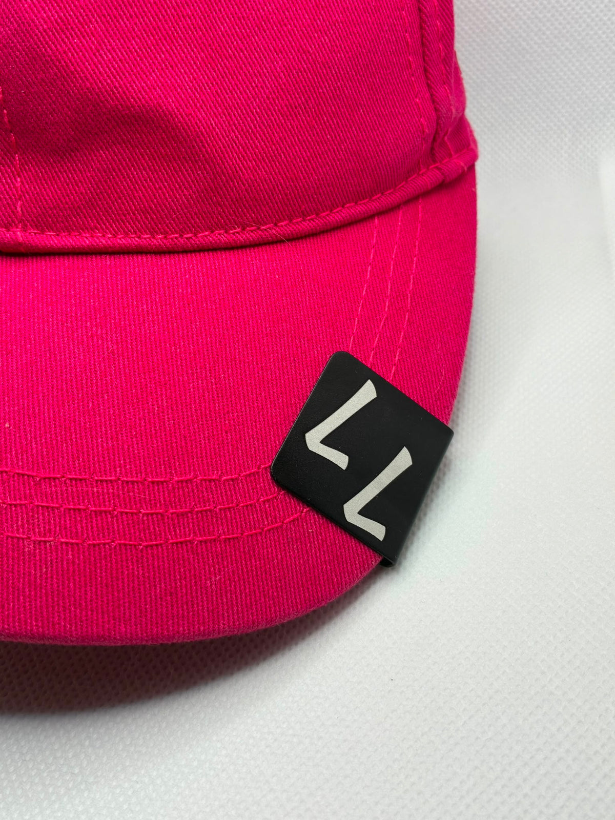 Personalised engraved black metal hat clip on a cap brim