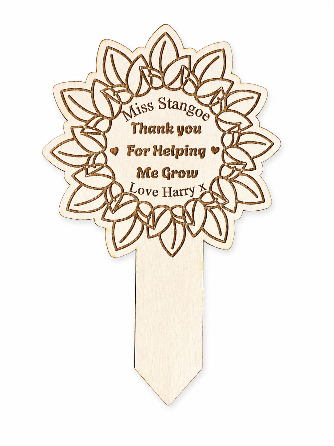A personalised wooden teacher thank you flower pick with engraved leaf patterns and the text 'Miss Stangoe Thank you For Helping Me Grow Love Harry x'.